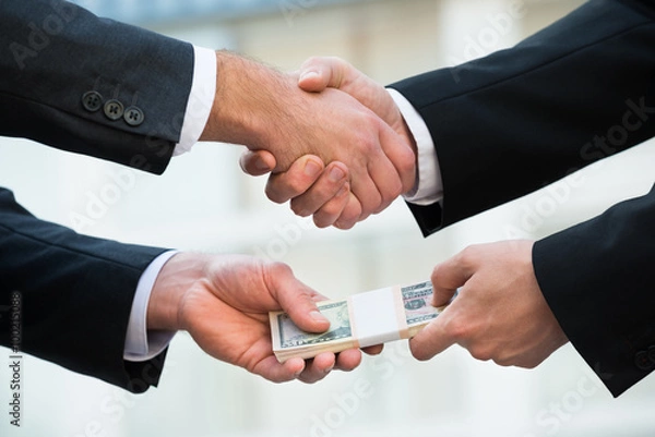 Fototapeta Businessman Shaking Hand While Bribing Partner