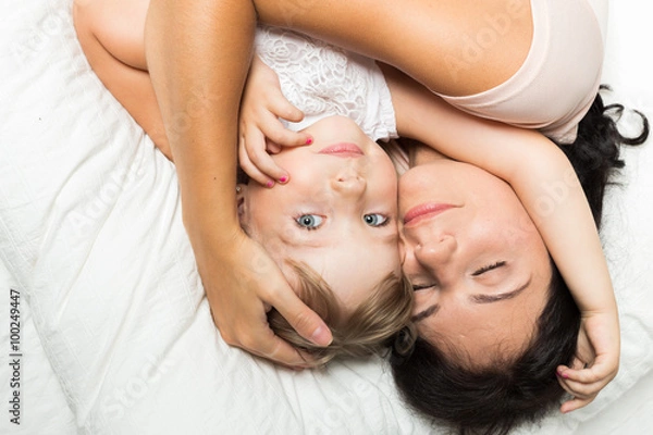 Fototapeta Mother and daughter in bed