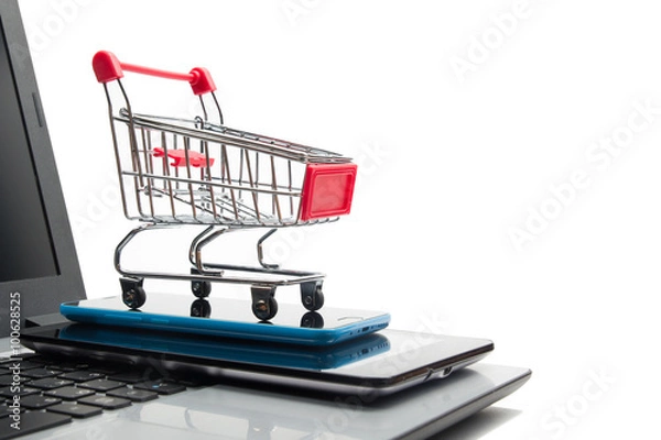 Fototapeta Online shopping concept - Empty Shopping Cart, laptop and tablet pc, smartphone isolated on white background. Copy space for text.