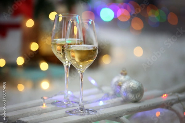 Fototapeta Two glasses of wine on Christmas decoration background