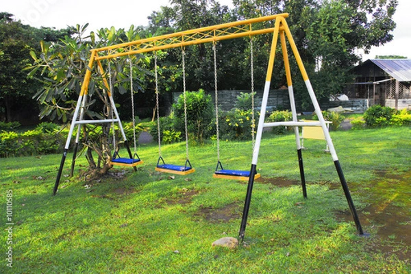 Fototapeta three seat swing in a children's playground.