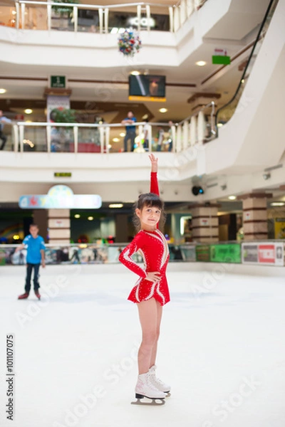 Fototapeta little girl skates figure skating victory sports suit