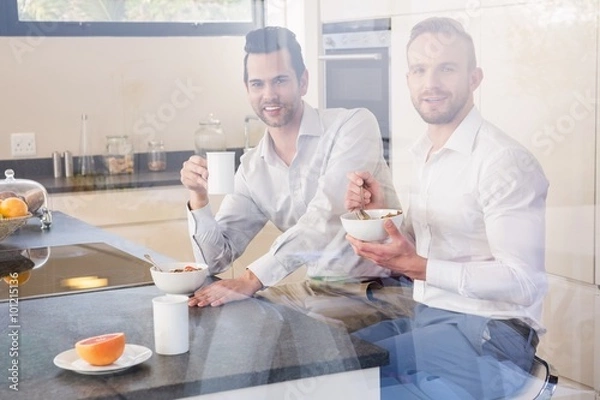 Fototapeta Smiling gay couple having breakfast