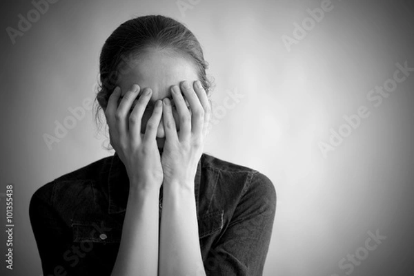 Fototapeta Depressed woman covering her face