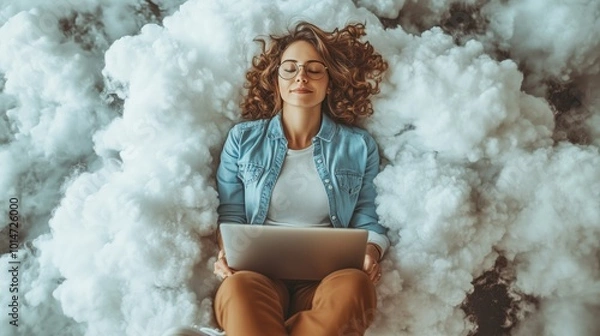 Fototapeta A woman in casual attire lies comfortably on cloud-like cushions, working or relaxing with a laptop, symbolizing cloud computing.