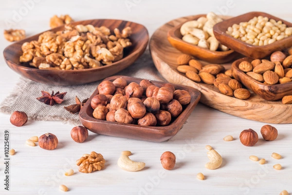 Obraz almonds, walnuts, hazelnuts cashews and pine nuts in wooden bowl