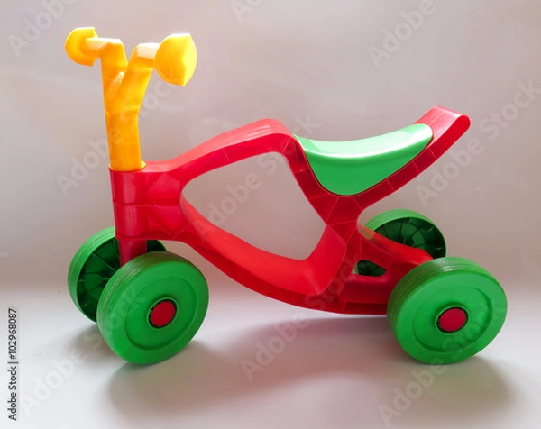 Fototapeta green plastic with red tricycle on white background