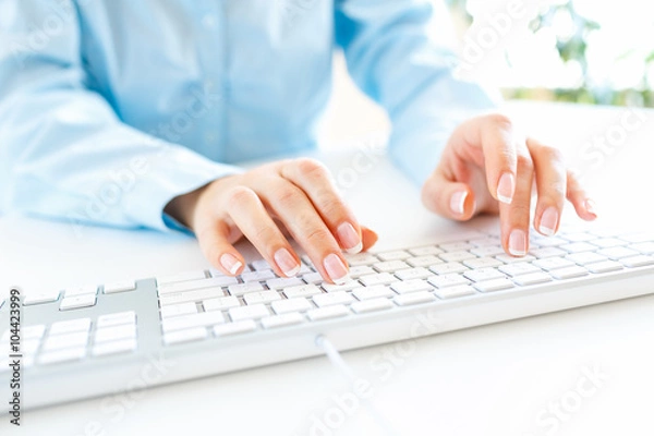 Fototapeta Woman office worker typing on the keyboard