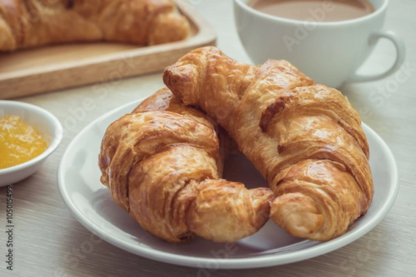 Fototapeta Fresh croissants on plate with jam and coffee cup