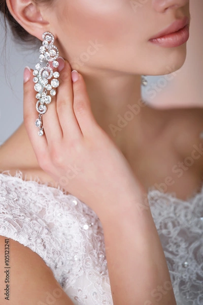 Fototapeta Beautiful bride with wedding makeup and hairstyle isolated in studio