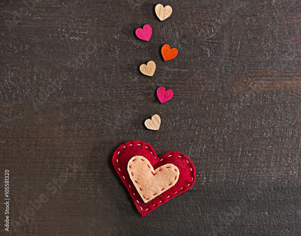 Fototapeta Valentine concept. Felt heart with small hearts on wooden background