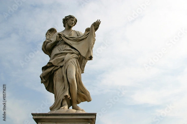 Fototapeta Bernini's angel along the Holy Angel bridge near the Hadrian Mausoleum in Rome, Italy 