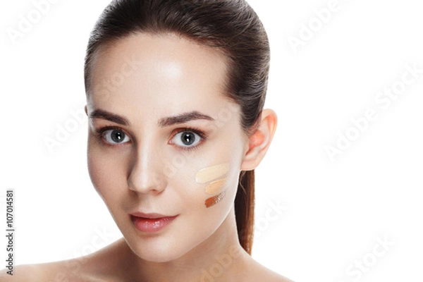 Fototapeta Beauty Girl Try to Different tones of Foundation Concealer. Natural Makeup for Brunette Woman with  Beautiful Face. Makeover. Perfect Skin. Applying Make-up. Ideal for commercial 