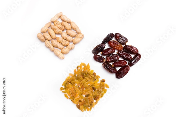 Fototapeta Peanuts, raisins and dried halawi  isolated on white background