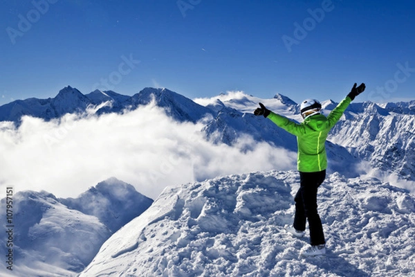 Fototapeta young woman is enjoying winter sports in Austrian Alps