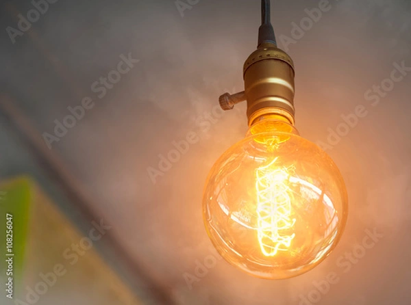 Obraz vintage light bulb glowing in the smoke