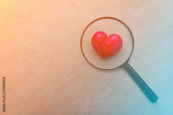 Fototapeta Magnifying glass and red heart