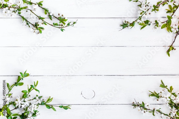 Fototapeta apple flowers on white wooden background, flat lay, top view