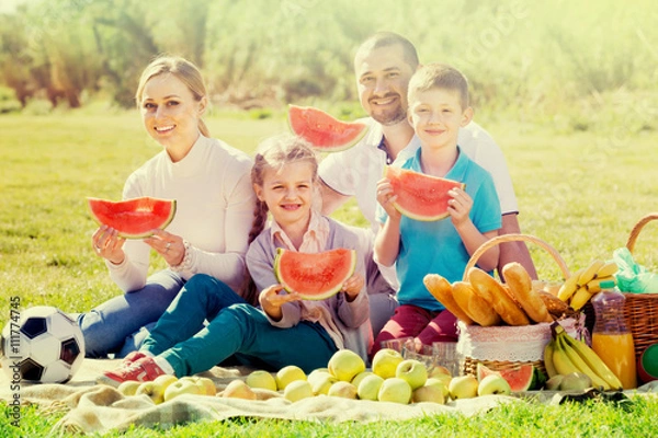 Fototapeta Family eating watermelon on the picnic.