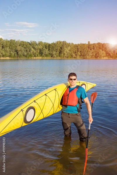 Fototapeta Man traveling on the river in a kayak in the summer.