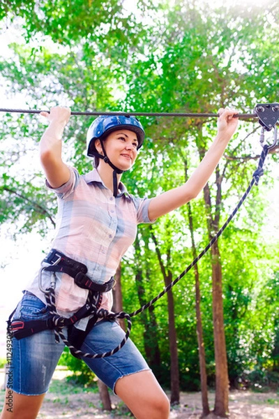 Fototapeta adventure climbing high wire park - people on course in mountain