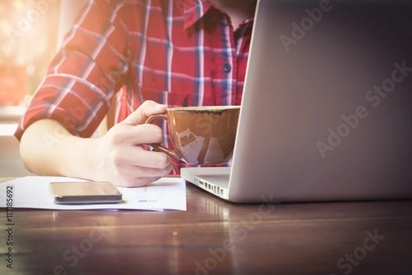 Fototapeta Business man holding cup of coffee vintage filter effect