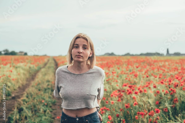 Fototapeta young caucasian female in poppy field