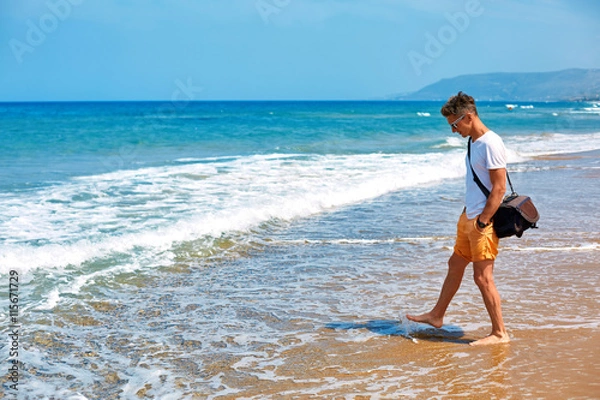 Fototapeta man walking on the beach