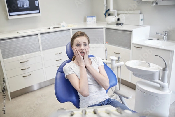 Fototapeta scared and terrified patient girl at dental clinic