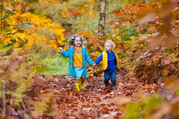 Fototapeta Kids playing in autumn park