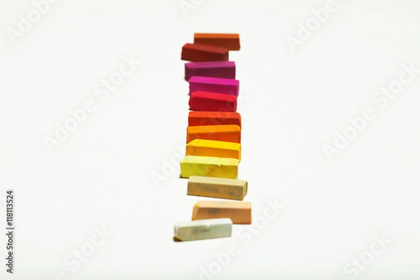 Fototapeta Diversity concept. Sheet of blank white paper with spectrum of warm colors