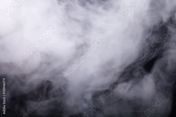 Fototapeta Cloud of smoke on black background. Selective focus