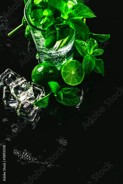 Fototapeta glass of mojito with lime and mint close-up ice cube on a dark background