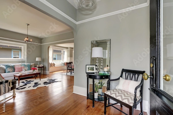 Fototapeta Entryway with gray walls, console table and wood floors