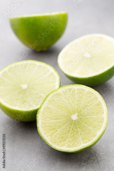 Fototapeta Juicy ripe lime an gray table.