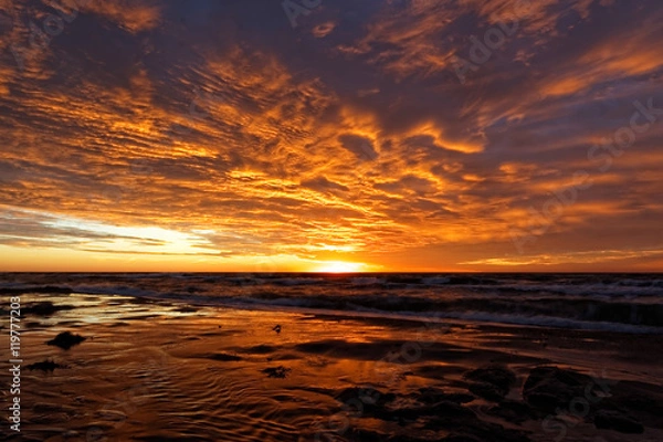 Fototapeta Orange sunset on the beach. Baltic Sea.