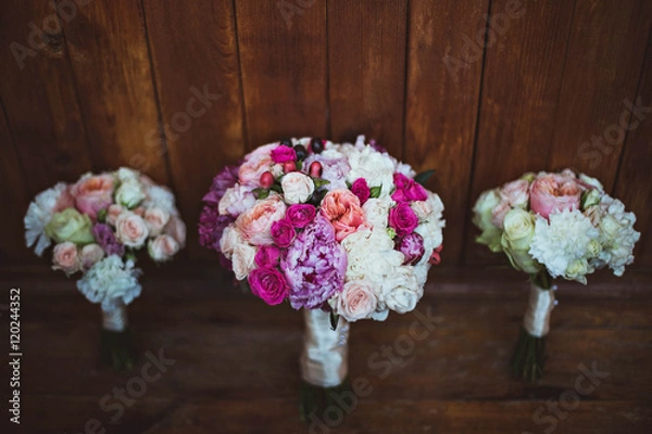 Fototapeta three colored bouquets made for the bride and bridesmaids