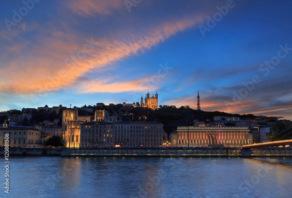 Fototapeta Colorful sunset over the Saone river and the Basilique Notre-Dame de Fourviere in the city of Lyon, France.