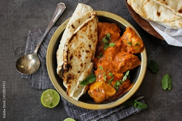 Fototapeta Butter Chicken served with homemade Indian Naan bread