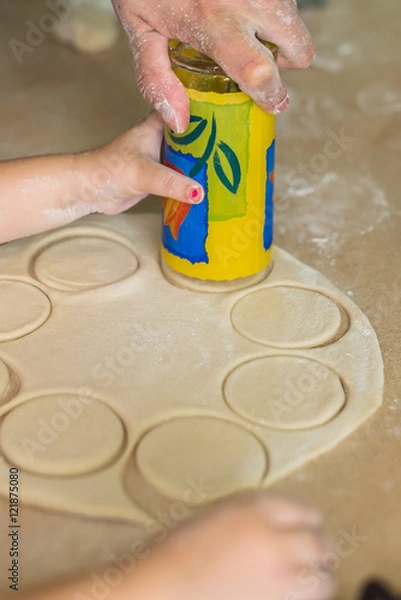 Fototapeta Children and dad cook hands the circles of dough