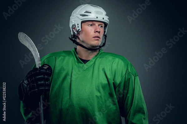 Fototapeta Hockey player holds gaming stick.