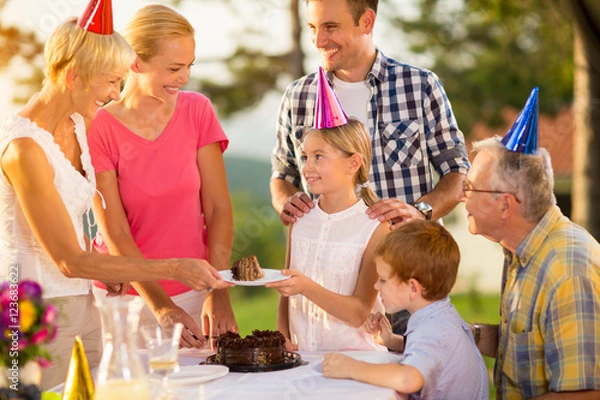 Fototapeta serving cake at birthday party.