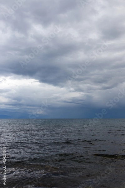 Fototapeta cloudy weather on the sea as background