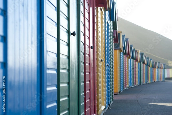 Fototapeta Brightly coloured traditional beach huts