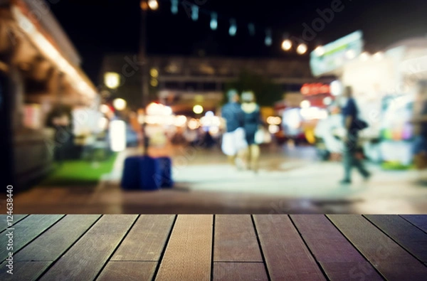 Fototapeta image of wooden table in front of abstract blurred background