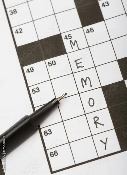 Fototapeta Crossword puzzle with a word memory and a black pencil. Good training for brains especially for elderly people.