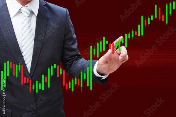 Fototapeta Businessman hand touching Candlestick Chart, investment concept