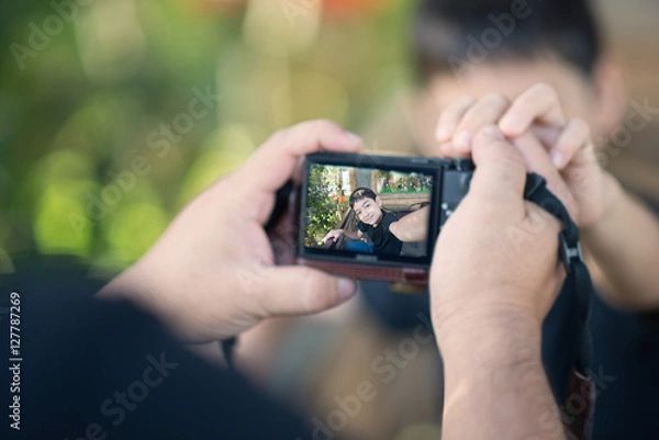 Fototapeta Little boy taking himself selfie outdoor summer time