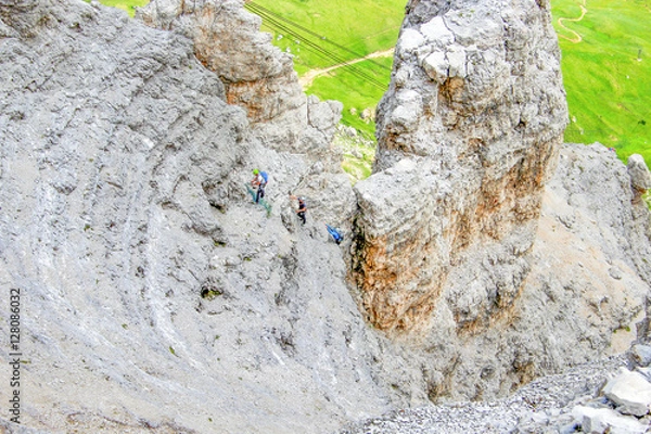 Fototapeta Climbers ascending Sass Pordoi mountain massif, Dolomites Alps, Italy, Europe