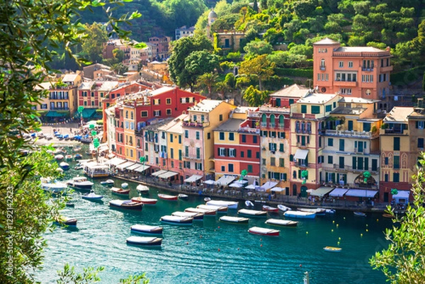 Fototapeta Italy travel and landmarks . Portofino -Luxury resort and beautiful colorful village in Liguria. Panoramic view with colorful houses and sail boats. .